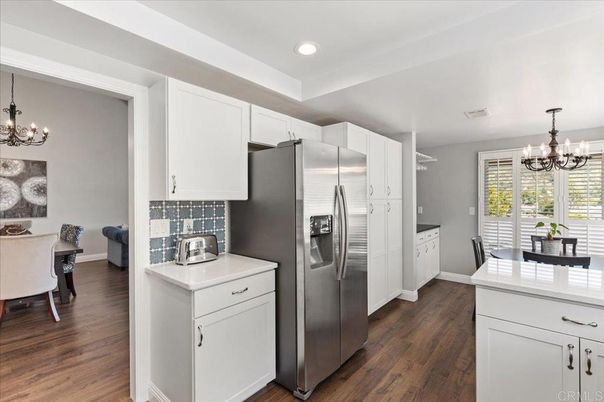 Chandelier, Dining room, Interior, Kitchen, Recessed Lighting, Stainless Steel Appliances, Wood Texture Flooring