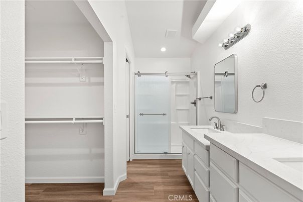 Bathroom, Dual Sink Vanities, Interior, Recessed Lighting, Walk-in Closets, Wood Texture Flooring