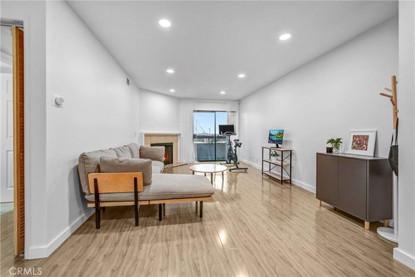 Fireplace, Fitness Equipment, Interior, Living room, Recessed Lighting, Wood Texture Flooring