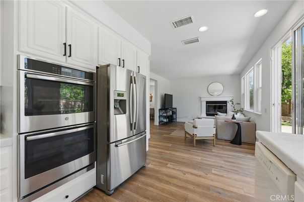 Fireplace, Interior, Kitchen, Living room, Recessed Lighting, Stainless Steel Appliances, Wood Texture Flooring