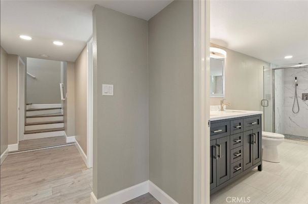 Bathroom, Glass Shower, Interior, Marble Walls, Recessed Lighting, Wood Texture Flooring