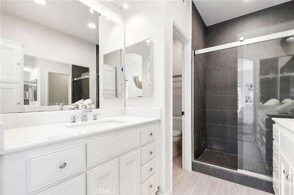 Bathroom, Dual Sink Vanities, Glass Shower, Interior, Recessed Lighting, Wood Texture Flooring