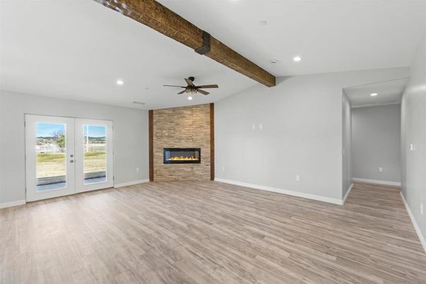 Empty room, Fireplace, Interior, Recessed Lighting, Stone Walls, Wooden Beams, Wood Texture Flooring