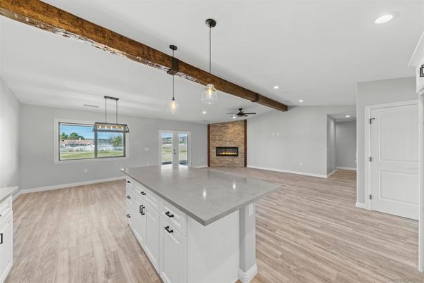 Empty room, Fireplace, Interior, Kitchen, Pendant Lights, Recessed Lighting, Wooden Beams, Wood Texture Flooring