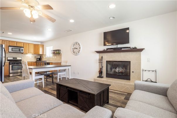 Dining room, Fireplace, Interior, Kitchen, Living room, Recessed Lighting, Stainless Steel Appliances, Wood Texture Flooring
