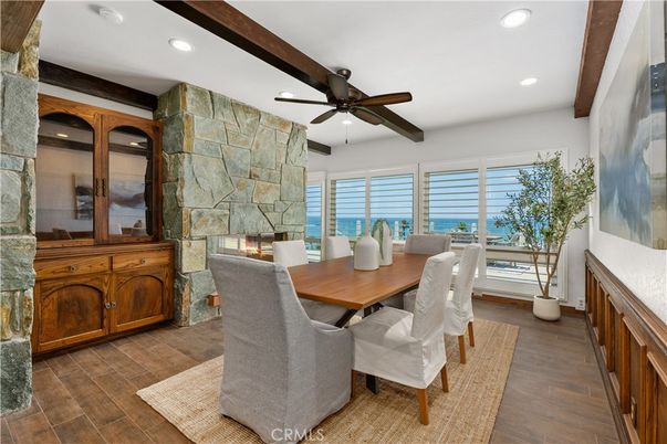 Dining room, Fireplace, Interior, Recessed Lighting, Stone Walls, Water, Wooden Beams, Wood Texture Flooring
