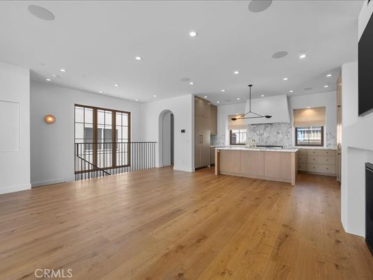 Fireplace, Interior, Kitchen, Marble Walls, Pendant Lights, Recessed Lighting, Stainless Steel Appliances, Wood Texture Flooring