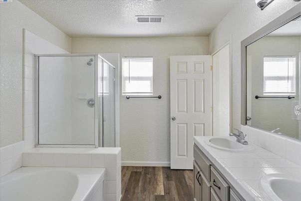 Bathroom, Dual Sink Vanities, Glass Shower, Interior, Tile Countertops, Wood Texture Flooring