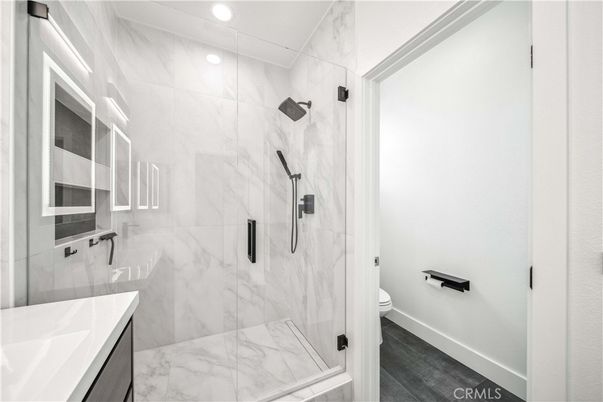 Bathroom, Glass Shower, Interior, Marble Walls, Recessed Lighting, Wood Texture Flooring