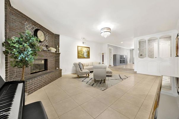 Chandelier, Fireplace, Interior, Living room, Piano, Recessed Lighting, Stone Walls, Wood Texture Flooring