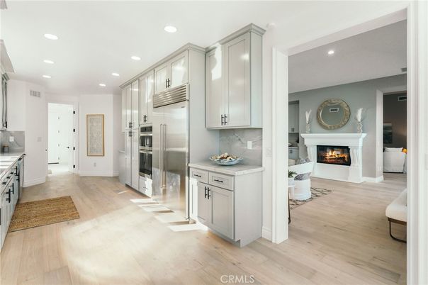 Fireplace, Interior, Kitchen, Recessed Lighting, Stainless Steel Appliances, Wood Texture Flooring