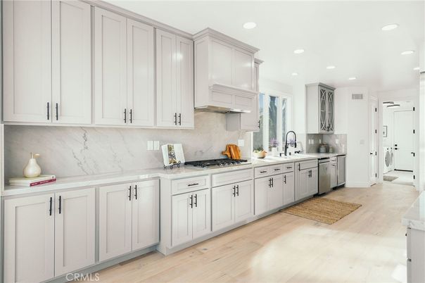 Interior, Kitchen, Marble Walls, Recessed Lighting, Stainless Steel Appliances, Wood Texture Flooring