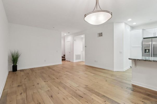 Empty room, Interior, Kitchen, Pendant Lights, Recessed Lighting, Stainless Steel Appliances, Wood Texture Flooring