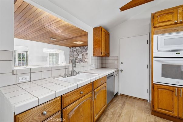 Interior, Kitchen, Tile Countertops, Wooden Ceilings, Wood Texture Flooring