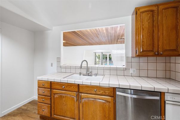 Interior, Kitchen, Stainless Steel Appliances, Tile Countertops, Wood Texture Flooring