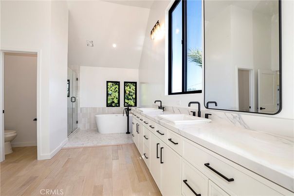 Bathroom, Dual Sink Vanities, Free Standing Baths, Glass Shower, Interior, Recessed Lighting, Wood Texture Flooring