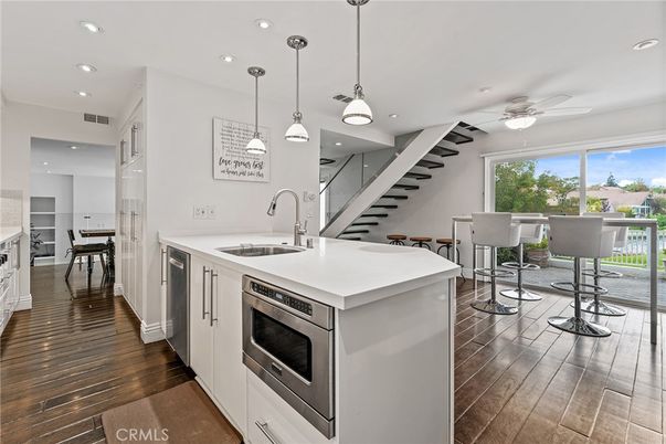 Dining room, Interior, Kitchen, Pendant Lights, Recessed Lighting, Stainless Steel Appliances, Wood Texture Flooring
