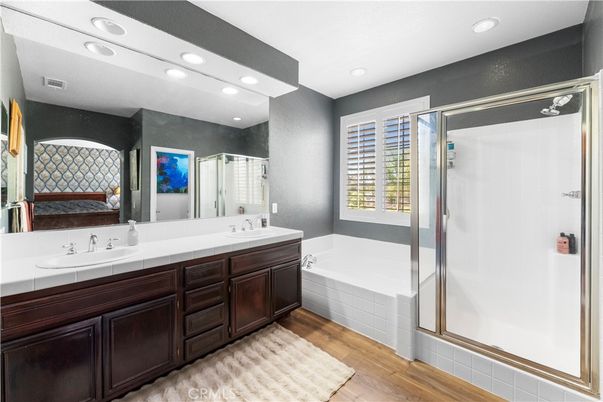 Bathroom, Dual Sink Vanities, Glass Shower, Interior, Recessed Lighting, Tile Countertops, Wood Texture Flooring