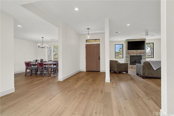 Chandelier, Dining room, Fireplace, Interior, Living room, Pendant Lights, Recessed Lighting, Wood Texture Flooring