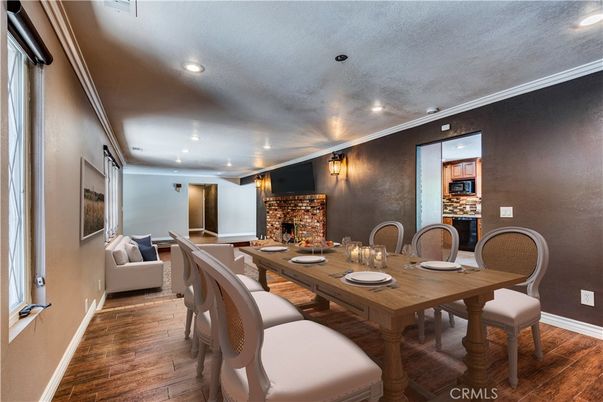 Dining room, Fireplace, Interior, Living room, Recessed Lighting, Wood Texture Flooring