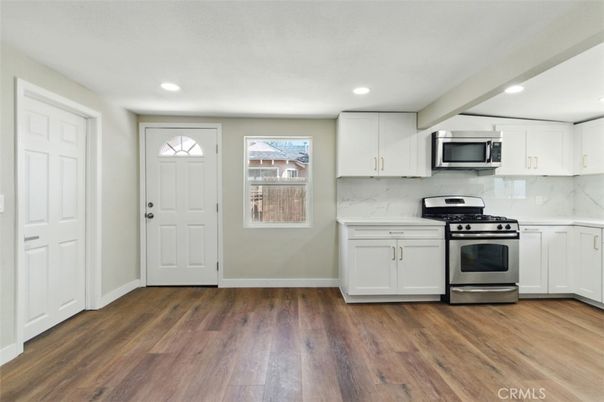 Interior, Kitchen, Marble Walls, Recessed Lighting, Stainless Steel Appliances, Wood Texture Flooring