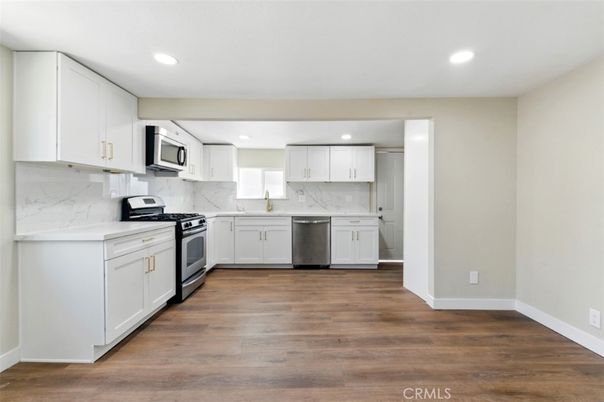 Interior, Kitchen, Marble Walls, Recessed Lighting, Stainless Steel Appliances, Wood Texture Flooring