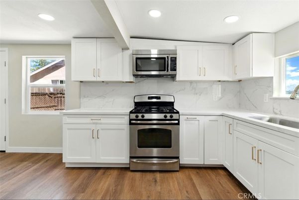 Interior, Kitchen, Marble Walls, Recessed Lighting, Stainless Steel Appliances, Wood Texture Flooring