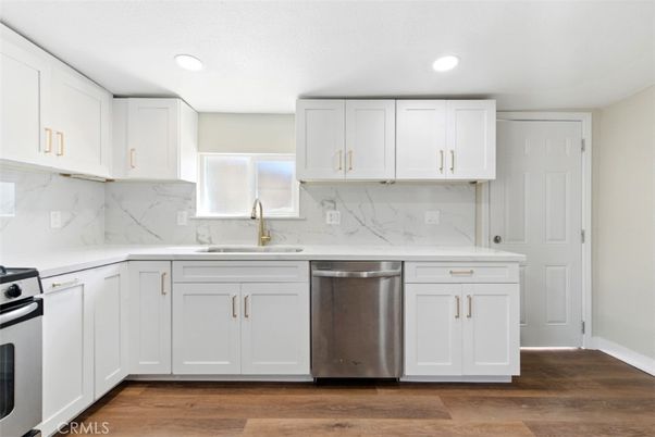 Interior, Kitchen, Marble Walls, Recessed Lighting, Stainless Steel Appliances, Wood Texture Flooring