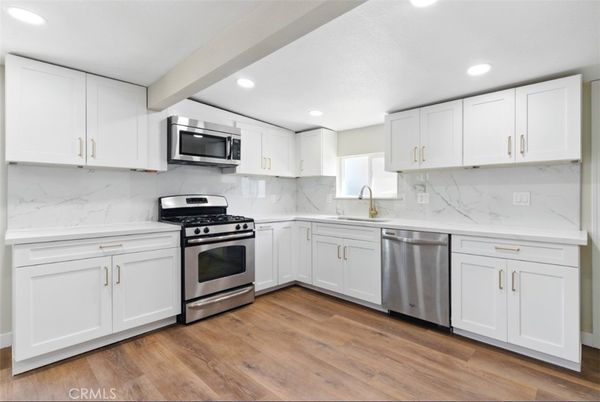 Interior, Kitchen, Marble Walls, Recessed Lighting, Stainless Steel Appliances, Wood Texture Flooring