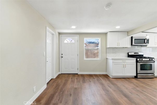 Interior, Kitchen, Marble Walls, Recessed Lighting, Stainless Steel Appliances, Wood Texture Flooring