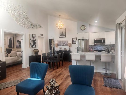 Chandelier, Dining room, Interior, Kitchen, Living room, Pendant Lights, Recessed Lighting, Stainless Steel Appliances, Wood Texture Flooring