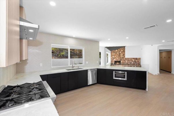Fireplace, Interior, Kitchen, Recessed Lighting, Stainless Steel Appliances, Wood Texture Flooring