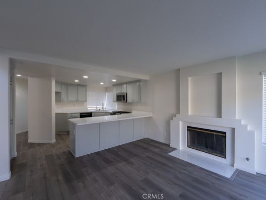 Fireplace, Interior, Kitchen, Recessed Lighting, Stainless Steel Appliances, Wood Texture Flooring