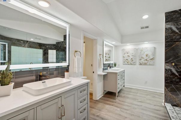 Bathroom, Dual Sink Vanities, Interior, Marble Walls, Recessed Lighting, Wood Texture Flooring