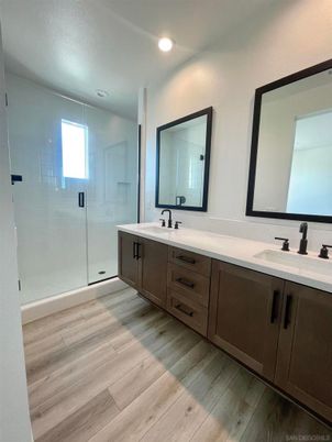 Bathroom, Dual Sink Vanities, Glass Shower, Interior, Recessed Lighting, Wood Texture Flooring