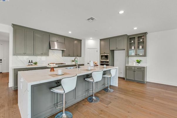 Interior, Kitchen, Marble Walls, Recessed Lighting, Stainless Steel Appliances, Wood Texture Flooring