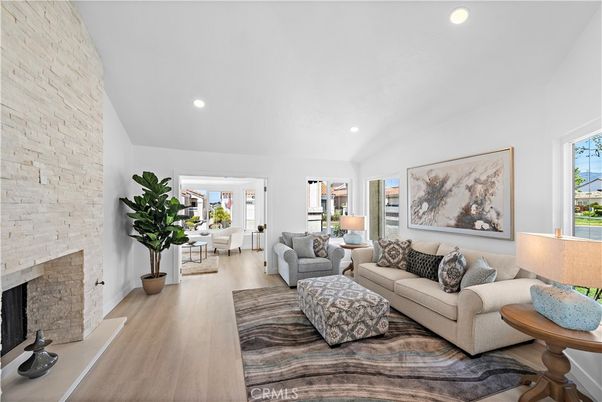 Dining room, Fireplace, Interior, Living room, Recessed Lighting, Stone Walls, Wood Texture Flooring