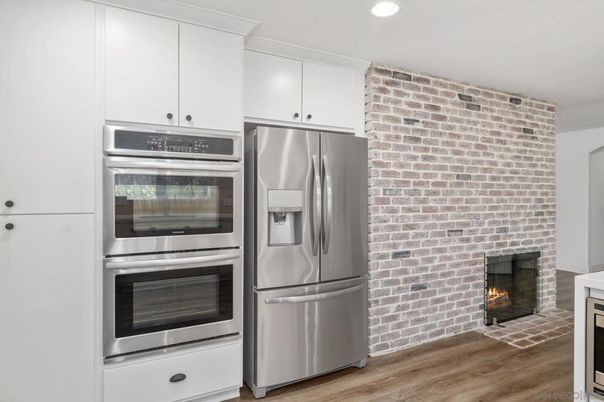 Fireplace, Interior, Kitchen, Recessed Lighting, Stainless Steel Appliances, Stone Walls, Wood Texture Flooring