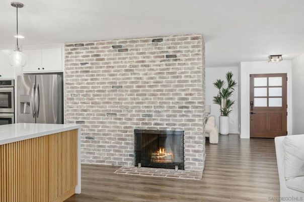 Fireplace, Interior, Kitchen, Pendant Lights, Recessed Lighting, Stainless Steel Appliances, Stone Walls, Wood Texture Flooring