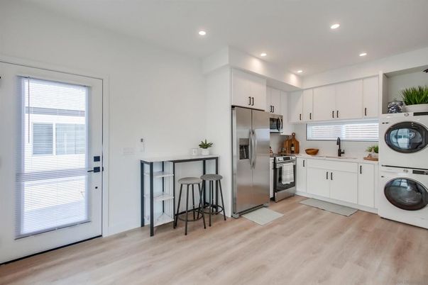 Interior, Kitchen, Recessed Lighting, Stainless Steel Appliances, Washer, Wood Texture Flooring