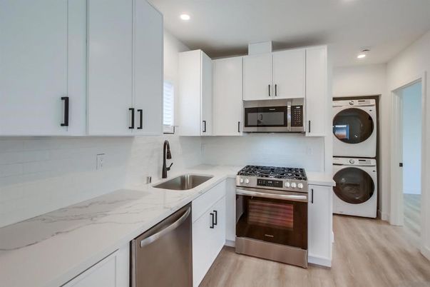 Interior, Kitchen, Recessed Lighting, Stainless Steel Appliances, Washer, Wood Texture Flooring