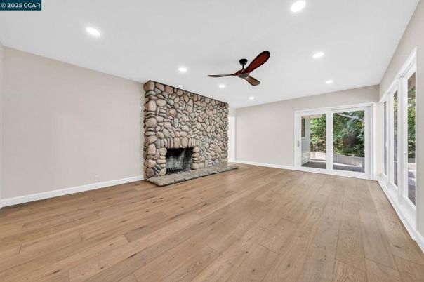 Empty room, Fireplace, Interior, Recessed Lighting, Stone Walls, Wood Texture Flooring