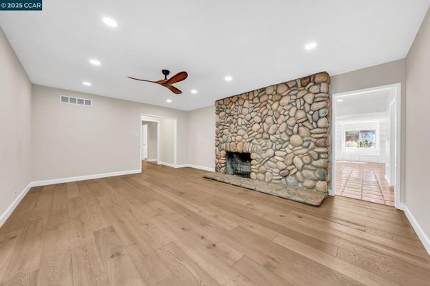 Empty room, Fireplace, Interior, Recessed Lighting, Stone Walls, Wood Texture Flooring