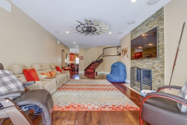 Dining room, Fireplace, Interior, Living room, Recessed Lighting, Stone Walls, Wood Texture Flooring