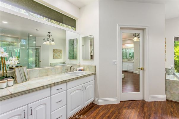 Bathroom, Dual Sink Vanities, Glass Shower, Interior, Recessed Lighting, Tile Countertops, Wood Texture Flooring