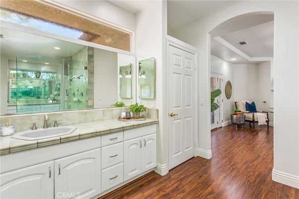 Bathroom, Dual Sink Vanities, Glass Shower, Interior, Recessed Lighting, Tile Countertops, Wood Texture Flooring