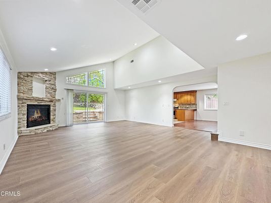 Empty room, Fireplace, Interior, Kitchen, Recessed Lighting, Stone Walls, Wood Texture Flooring