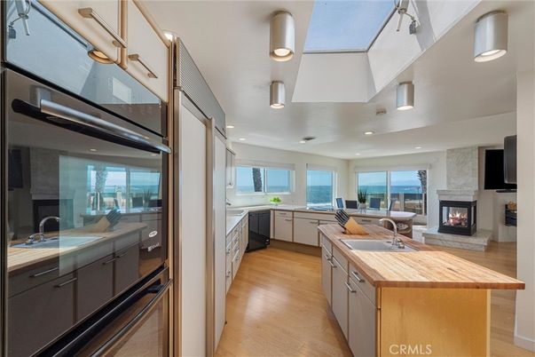 Fireplace, Interior, Kitchen, Living room, Recessed Lighting, Water, Wood Texture Flooring