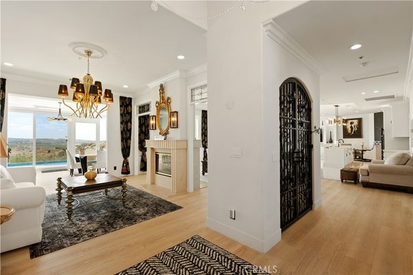 Chandelier, Dining room, Fireplace, Interior, Living room, Pendant Lights, Recessed Lighting, Water, Wood Texture Flooring