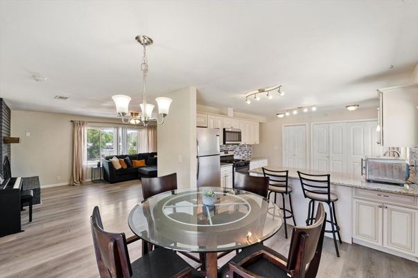 Chandelier, Dining room, Interior, Kitchen, Living room, Pendant Lights, Stainless Steel Appliances, Wood Texture Flooring